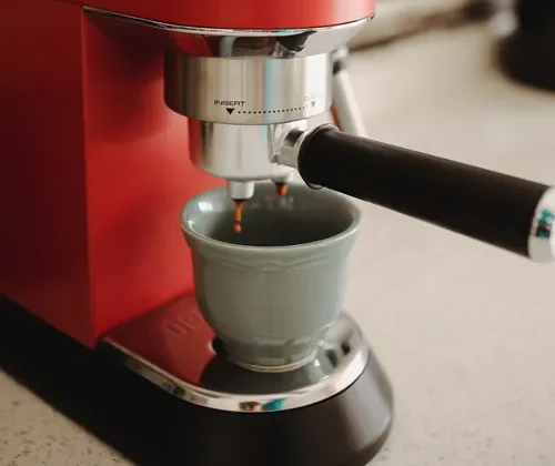 Espresso pouring from a home machine into a cup